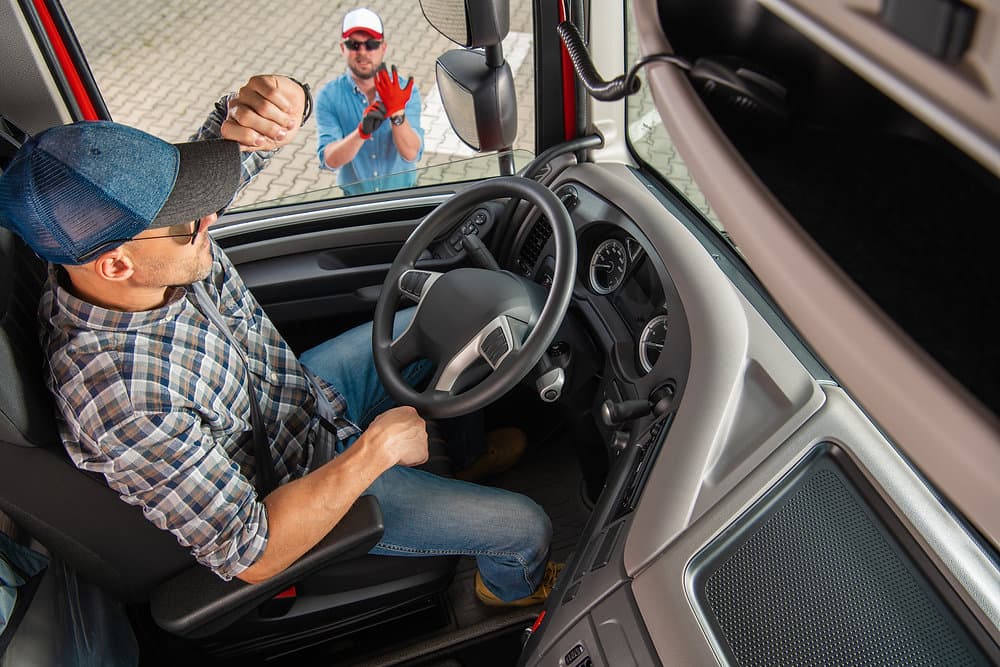 When should trucking companies hire a dedicated safety director?